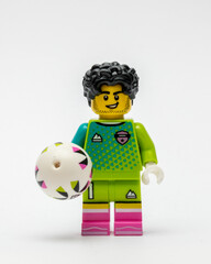 Obraz premium A minifigure of a footballer holding a football