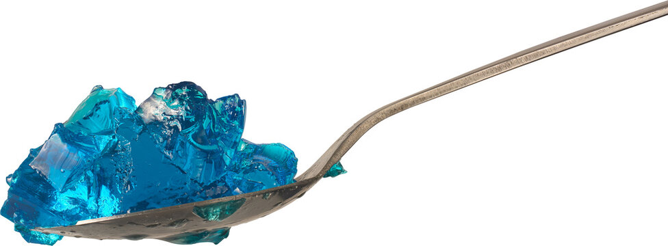 translucent blue gelatin jelly chunks on silver metal spoon isolated white background, glossy wet texture dessert, side view