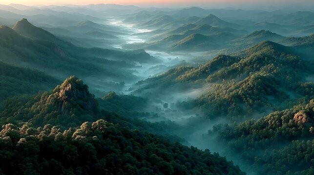 Misty mountain landscape at dawn with soft glowing sunrays images