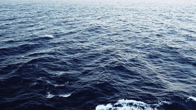 Sailing through endless shades of blue. Stunning ocean view from a cruise ship. Nothing but deep blue waters and open skies