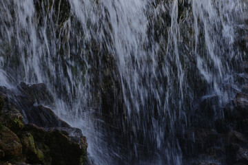 Water cascades over jagged rocks with force and grace © gelog67