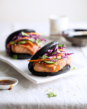 Black bao bun with salmon and purple cabbage slaw, Asian fusion street food