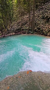 Scenic cascade waterfall with turquoise water in natural pools, Indonesia