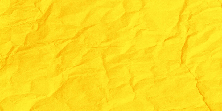Vibrant yellow crumpled paper texture background with deep wrinkles and creases for design and decoration