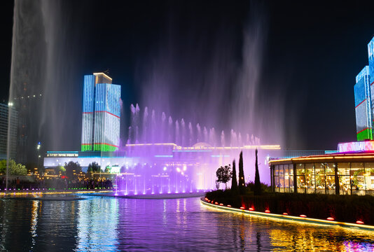 Tashkent, Uzbekistan- October 4 2024: Tashkent City Park and the far view of Tashkent city mall with the reflection of Uzbekistani flag