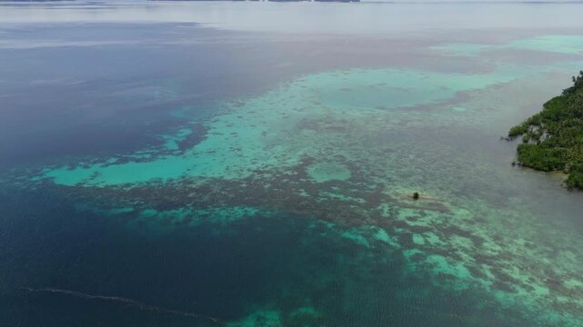 Epic cinematic tracking shot over majestic coastal landscapes of Banggai Sulawesi &ndash; Hidden tropical paradise islands with calm transparent lagoons, professional marketing video for travel tourism