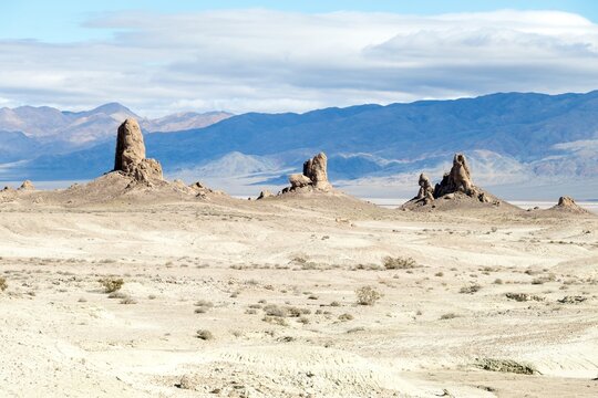 Distant tufa formations across pale desert floor at Trona Pinnacles