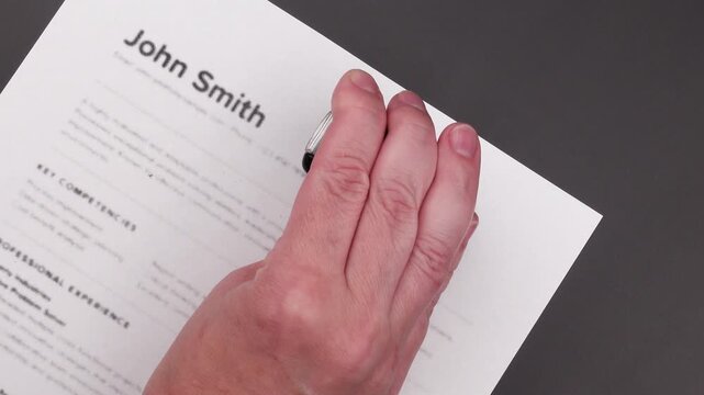 Human Review Required stamp on Fake mock CV (curriculum vitae) resume, concept of ATS auto-screening, AI filtering, and manual recruiter evaluation.