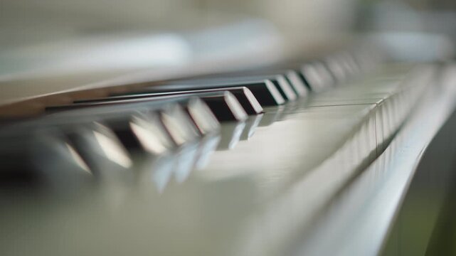 Angled piano keys with natural light and reflections, slow dolly perspective along keyboard, coach guiding adult student through phrasing and dynamics, cinematic shallow focus, polished studio vibe,