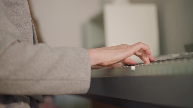 Side piano keys hands playing gentle ballad in home studio, closeup of forearms and fingers shaping chords, coach guiding student through voicings and touch, soft warm lighting and calm atmosphere,