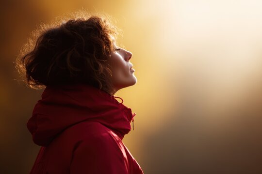 woman in red jacket standing in autumn forest breathing fresh air with eyes closed, wellness mindfulness nature therapy concept, warm golden sunlight through trees