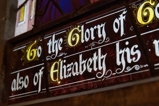 stained glass panel with illuminated, decorative script at Gloucester Cathedral - Gloucester - Gloucestershire - UK