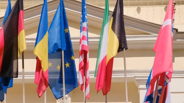 International flags of different countries waving in the wind