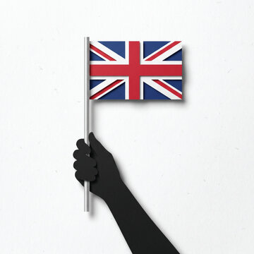 Hand holding United Kingdom flag vector illustration, minimalist black silhouette arm waving UK Union Jack on a stick, isolated British national symbol graphic element on white background