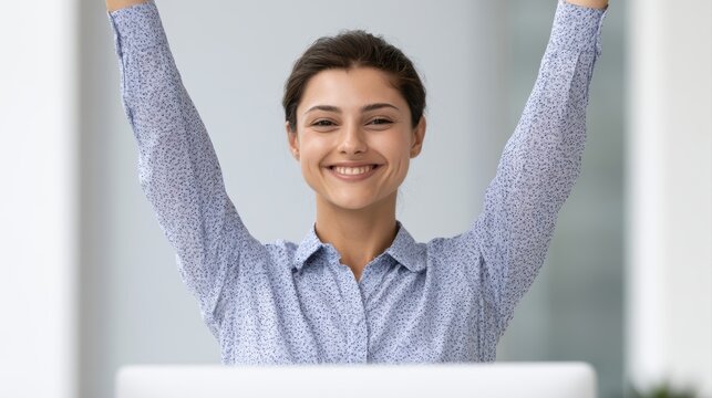 Businesswoman celebrating finishing all office work at modern computer desk