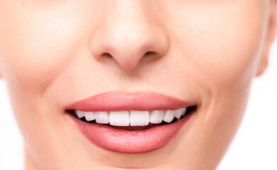 Fototapeta premium Smiling person with perfect teeth and soft lips against white background