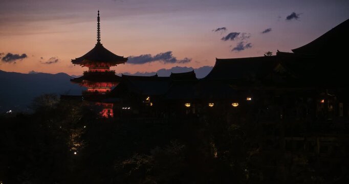 Kiyomizu-dera Japanese temple on hilltop at dusk - Silhouetted wide shot