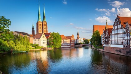 Fototapeta premium lubeck trave river view with old town houses and church spires