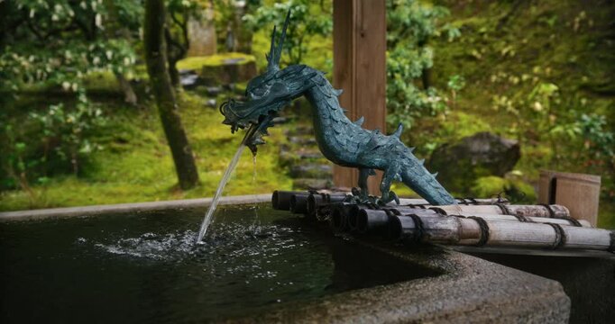 Small dragon statue fountain in Japanese village - closeup shot