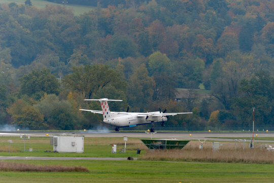 Croatia Airlines propeller airplane type De Havilland Canada Dash 8-400 registration 9A-CQF landing at Swiss Z&uuml;rich Airport on an autumn day. Photo taken October 17th, 2025, Oberglatt, Switzerland.