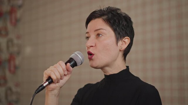 Dynamic performer showcasing emotional depth and technical mastery in singing. Talented vocalist expressing profound emotion through precise phrasing and sustained vocal vibrato skillfully