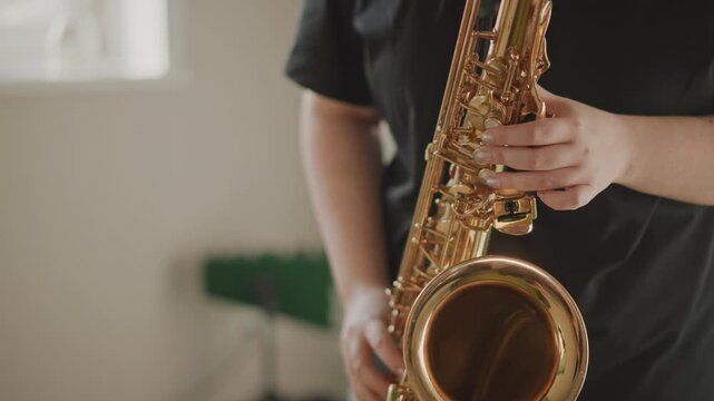 Performing with vintage warm tone. Intimate studio environment capturing focused saxophone performance. Engineer records indepth saxophone take with warm vintage tone and precise phrasing