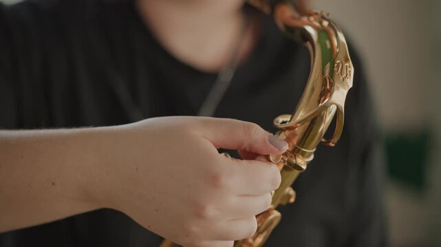 White musician fine tuning saxophone keys closeup, delicate hand movements, precision adjustment of pads and screws, workshop light, maintenance and tutorial vibe for instrument care