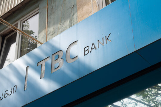 Tbilisi, Georgia - May 20, 2026: Street photo. TBC bank logo on blue wall. Bottom view. Concept of pay tax, loan, debt, payment, terminal machine cash money, ATM, plastic card, salary, credit, salary