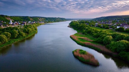 Obraz premium River Flows Through Green Landscape at Dawn Near Small Town