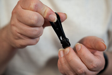 Fototapeta premium Careful Fingernail Clipping For Personal Hand Care Routine close up during a regular hygiene procedure focused on maintaining neat healthy nails and well groomed hands
