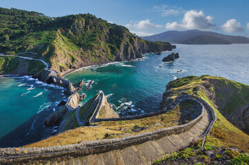 Winding Stone Staircase Leading Down to a Dramatic Coastal Bay with Turquoise Waters and Rocky Cliffs, San Juan de Gaztelugatxe, Basque Country, Spain © EyesTravelling