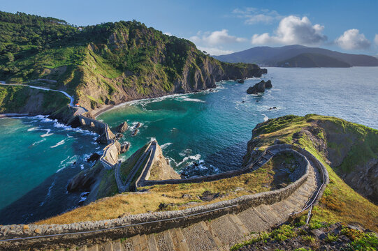 Winding Stone Staircase Leading Down to a Dramatic Coastal Bay with Turquoise Waters and Rocky Cliffs, San Juan de Gaztelugatxe, Basque Country, Spain