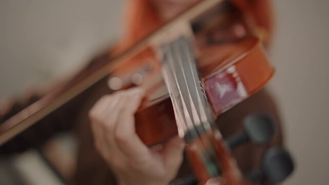 Tight violin closeup showing fingerwork on strings and tuning pegs, detailed view of bridge and varnish warm acoustic focus, subtle resonance, microphone ready for intimate recording or close mic