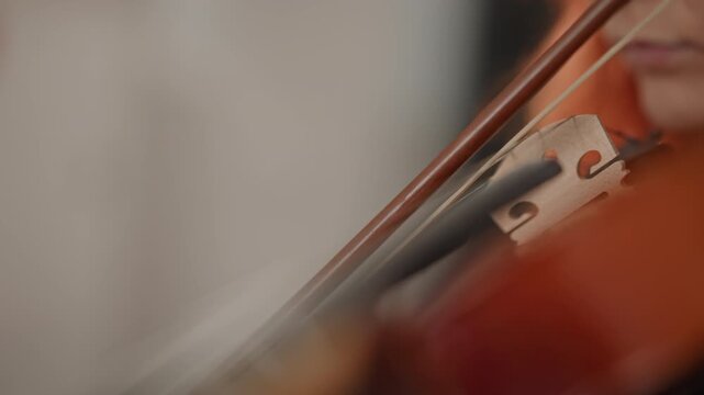 Redhead caucasian violinist handson lesson with coach, closeup of hands and finger placement on fingerboard, teacher adjusting posture, bow pressure guidance, warm classroom atmosphere