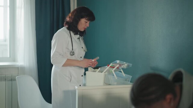 Medical aid at home. Healthcare professional sorting medicines in reassuring home setting. Female medical practitioner arranging medical supplies at home with attentive patient support