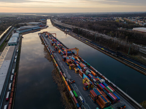 Aerial view of the intermodal container terminal at the inland port in Gliwice, Poland. Industrial landscape with freight trains at sunset.
