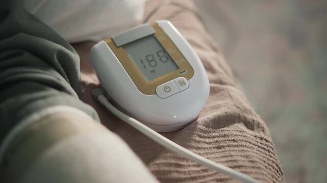 Monitoring health with remote nurse assistance. Digital cuff captures consistent blood pressure readings at home. Nurse analyzes blood pressure data remotely during routine health check at home