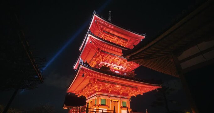 Cinematic reveal of ancient, glowing Japanese tower at temple with spotlights