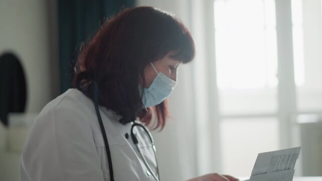 Medical professional methodically assesses papers of patient outdoors. Healthcare specialist thoroughly investigates and reviews all relevant medical and personal documents outside