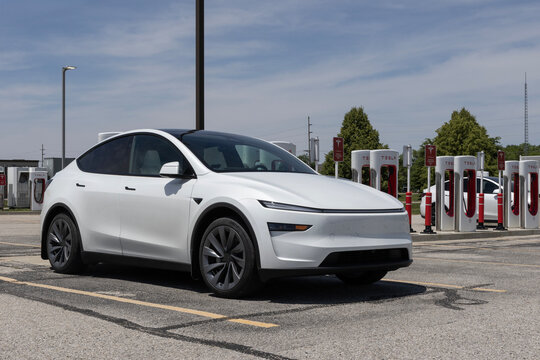 Tesla EV electric vehicle at a supercharger. Tesla models include the Cybertruck, Model 3, Model Y, Model X and Model S.