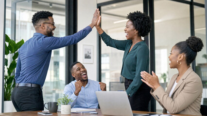 Obraz premium African American business professionals celebrating success with high five in office meeting