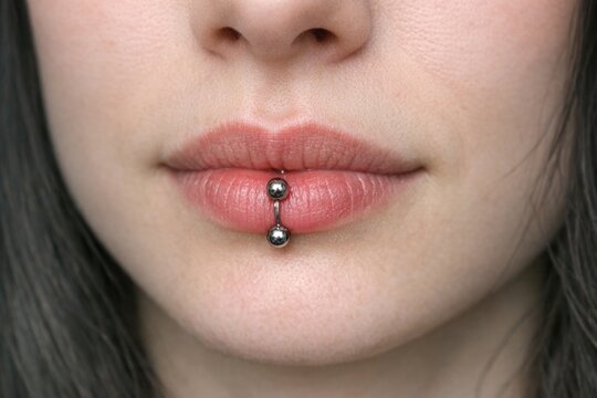 A close-up shot of a person's face with a visible nose piercing