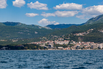 Fototapeta premium Breathable maritime view of the cascading stone town and coastal promenade of Herceg Novi from the open sea
