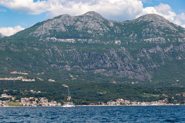 Fototapeta premium Dramatic rocky coastline and pristine azure waters along the sun-drenched Adriatic Sea shore of Montenegro