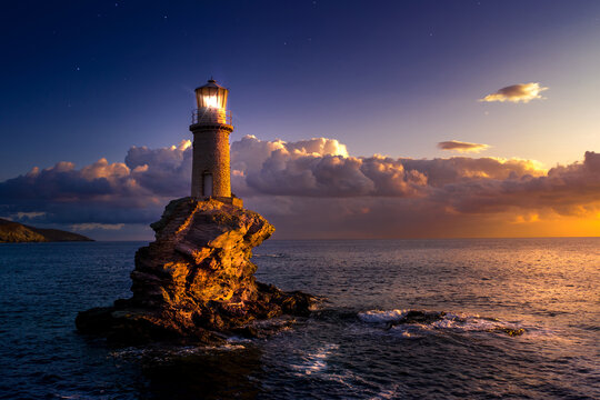 The beautiful Lighthouse Tourlitis of Chora at night. Andros island, Cyclades, Greece