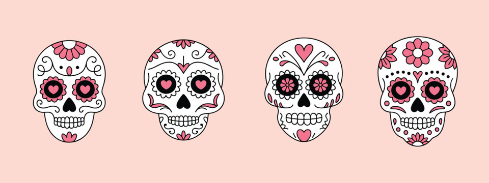 Four decorated sugar skulls with pink floral and heart patterns on a pale pink background calavera day of the dead