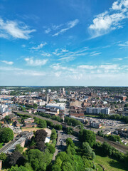 Obraz premium High Angle View of Residential District at Luton City During Hot Sunny Summer Day. Drone Flight Above Urban City Streets and Homes Over British City and Town of England United Kingdom.