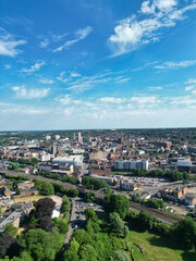 Obraz premium High Angle View of Residential District at Luton City During Hot Sunny Summer Day. Drone Flight Above Urban City Streets and Homes Over British City and Town of England United Kingdom.