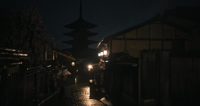 Heavy rain storm on empty, old Japanese village cobblestone road at night - steady cam
