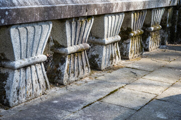 Naklejka premium A traditional korean stone bridge balustrade with unique carved patterns at a temple entrance.